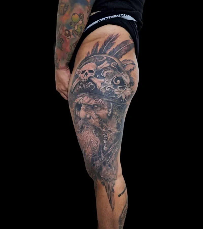 Skull and elder portrait thigh tattoo, black and grey